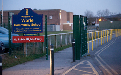 A school has banned mobile phones after pupils posted videos online of a 15-year-old boy being stabbed in the playground